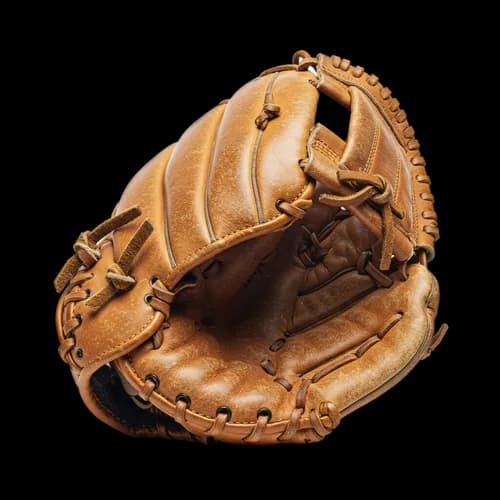 Old brown leather baseball glove for sports