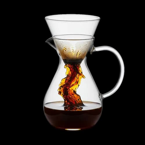 Fresh coffee dripping into a glass pour over carafe