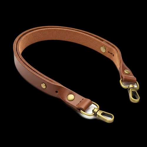 Brown leather camera strap with brass metal clips