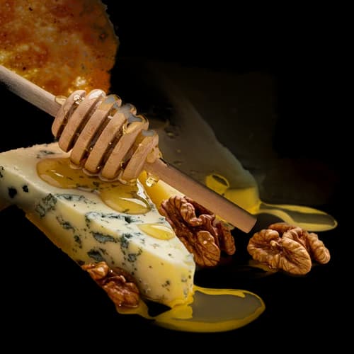Blue cheese with honey dipper and walnuts
